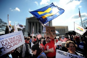 Demonstrators gather in front of the U.S. Supreme Court on Wednesday, March 27, 2013, as the court hears arguments on a part of the 1996 Defense of Marriage Act that prevents legally wed same-sex couples from receiving certain benefits by defining marriage as between a man and woman. (Olivier Douliery/Abaca Press/MCT)