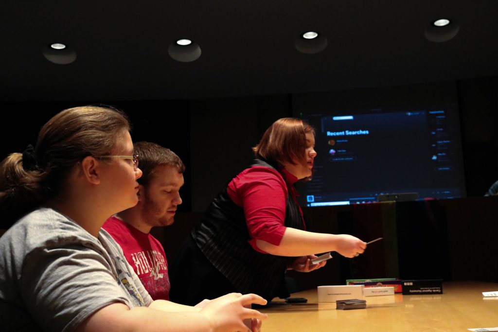 Graduate Sara Booker setting up a card game for Pride!Kent members Thursday night. Photo by Cameron Glover.